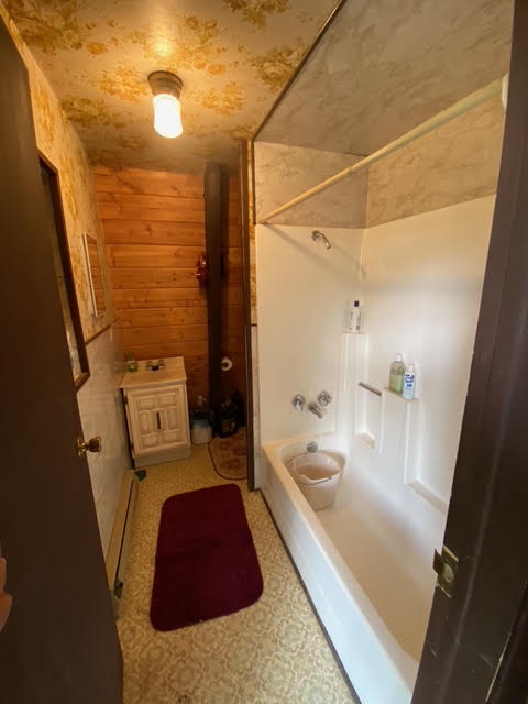 The cabin's original worn bathroom before renovation