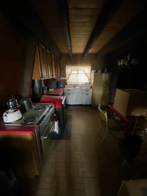The cabin's original dark, dated kitchen before renovation