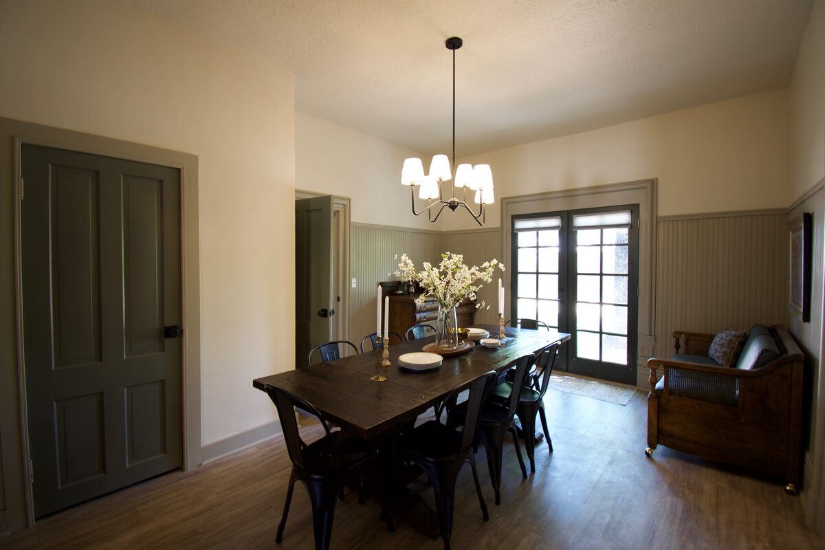 The home's new dining room with a farmhouse table and French doors