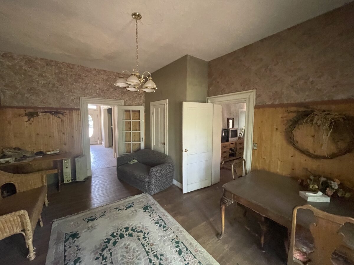 A front sitting room in the home before renovation, later reimagined as the dining room