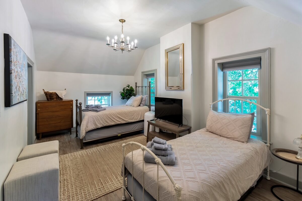 An upstairs bedroom with two twin beds